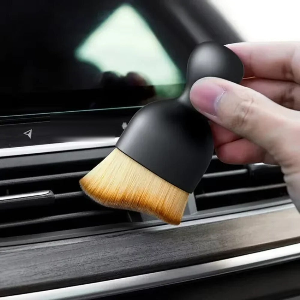 Soft detailing brush cleaning a car air vent