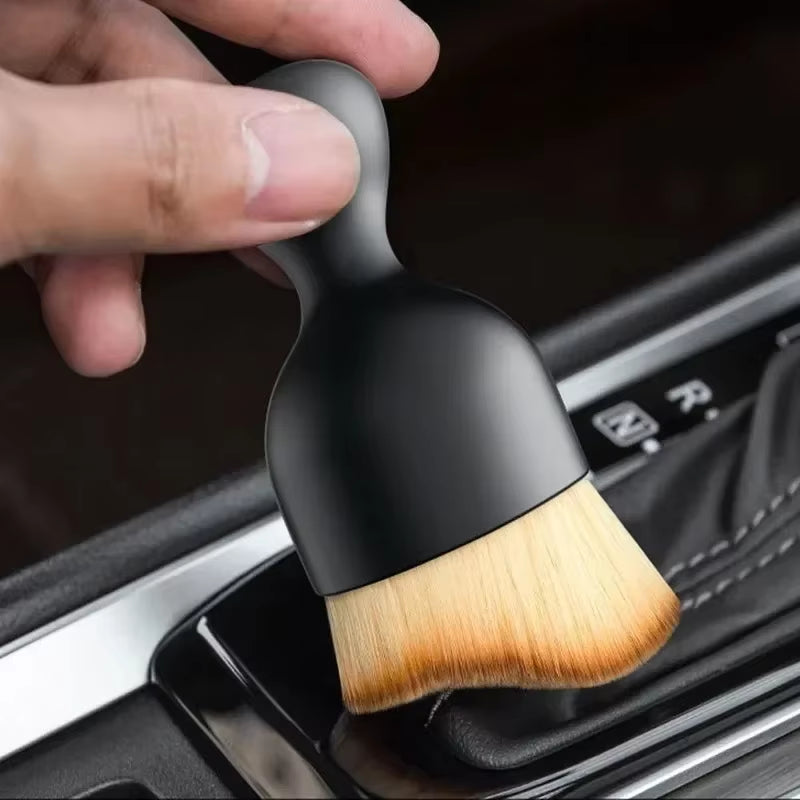 Soft detailing brush cleaning a car air vent